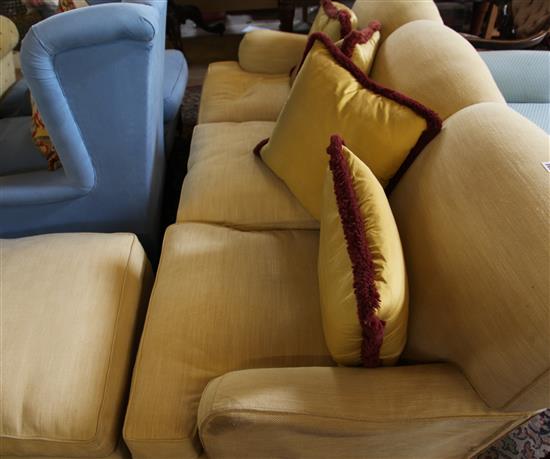 A yellow fabric upholstered settee and pouffe